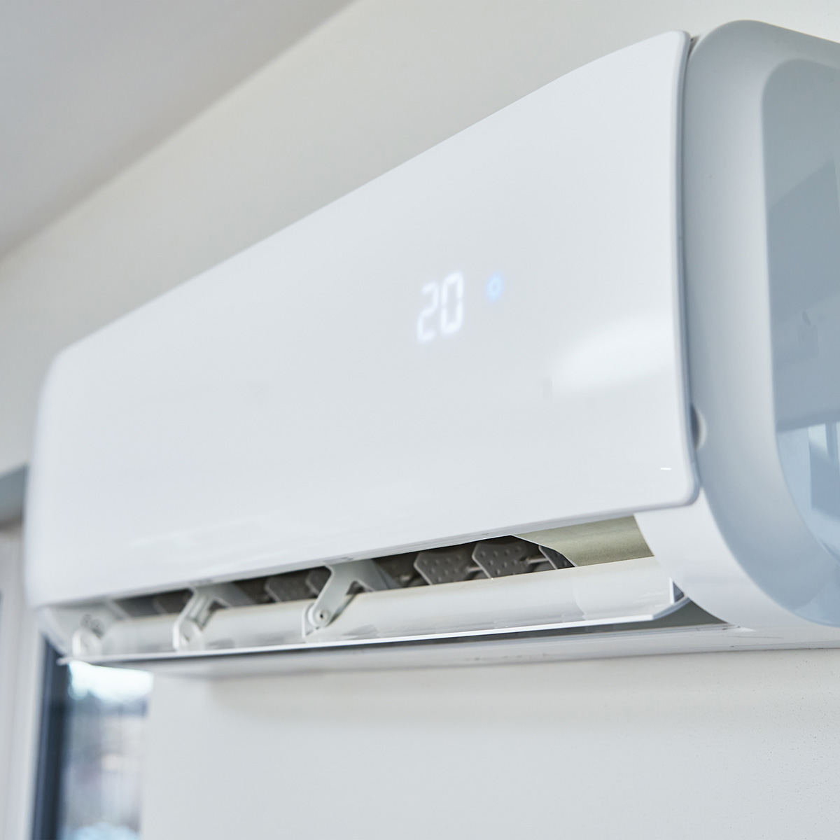 Adjusting temperature on air conditioner, Working air conditioner for comfort temperature in home at hot summer, cooling air in the room